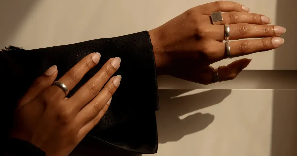 Model image of hand with rings promoting jewelry