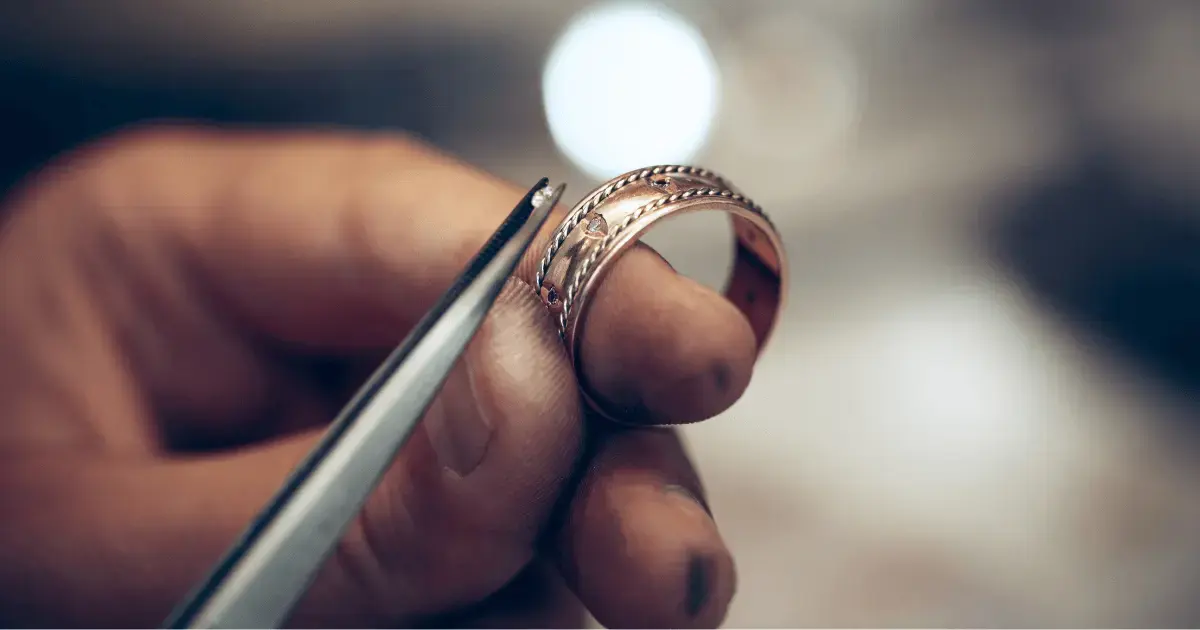 Man replacing the gemstones in a ring