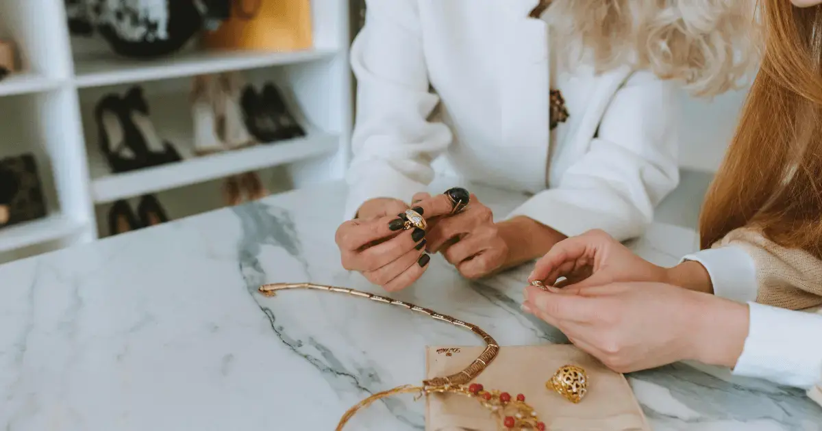 people looking at jewelry on the counter in a jewelry store